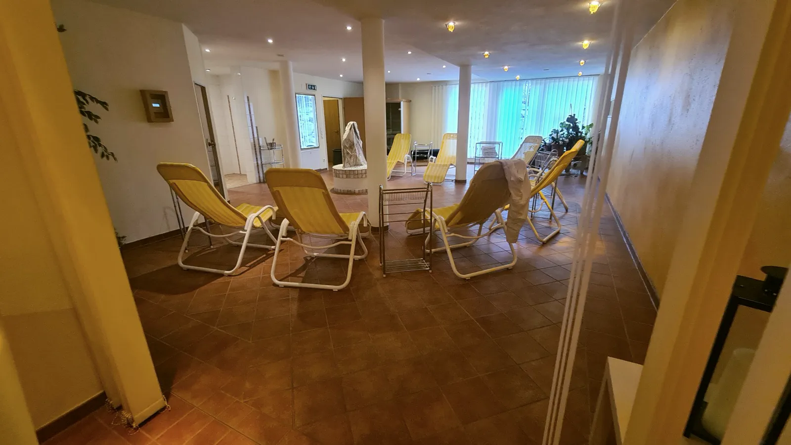 View into the relaxation room with loungers and windows